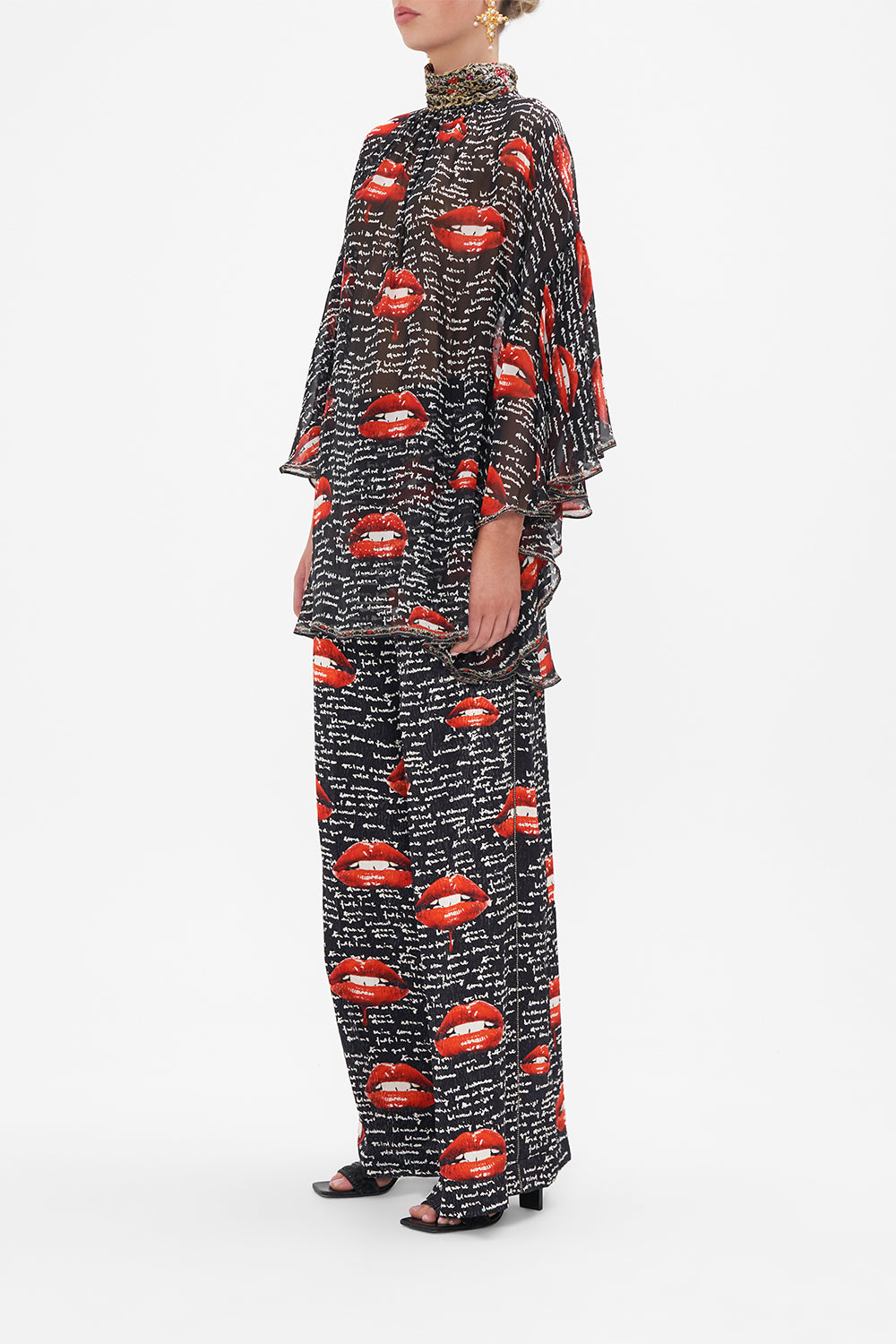 Side view of model wearing CAMILLA black silk blouse in Chaos Magic print