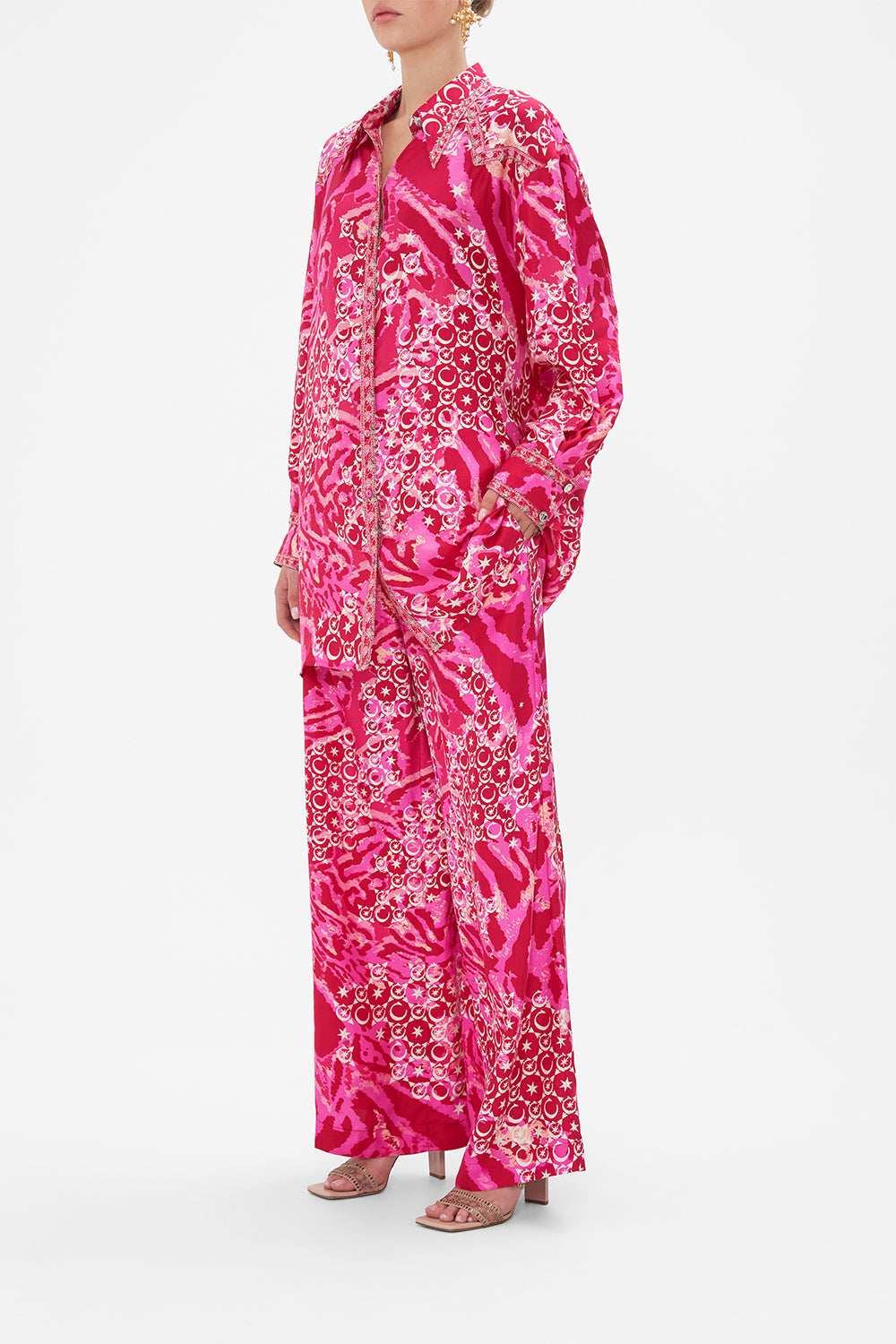 Side view of model wearing CAMILLA silk shirt in Song Of Sacrifice print