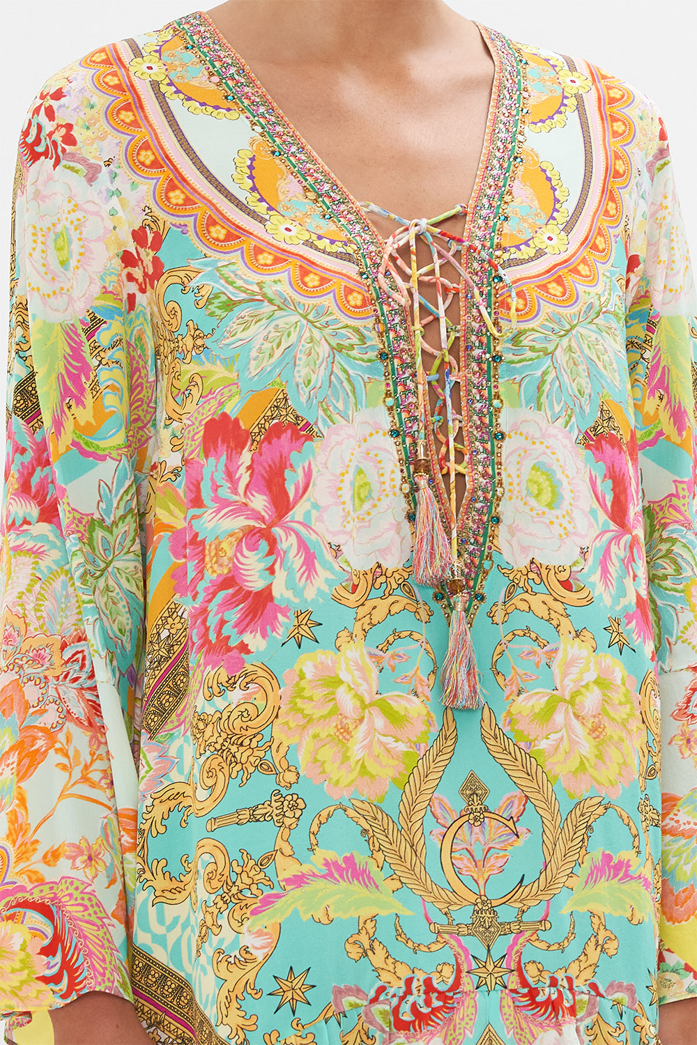 Detail view of model wearing CAMILLA silk mini dress with high low hem in An Italian Welcome print