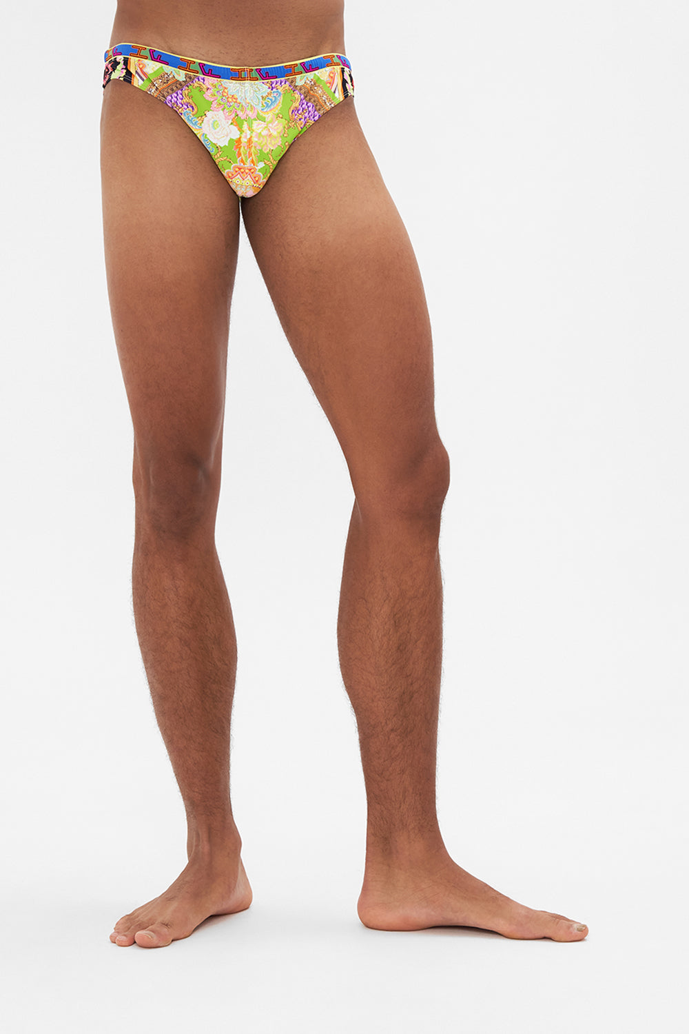 Crop view of model wearing HOTEL FRANKS BY CAMILLA mens swim in Sundowners in Sicily print