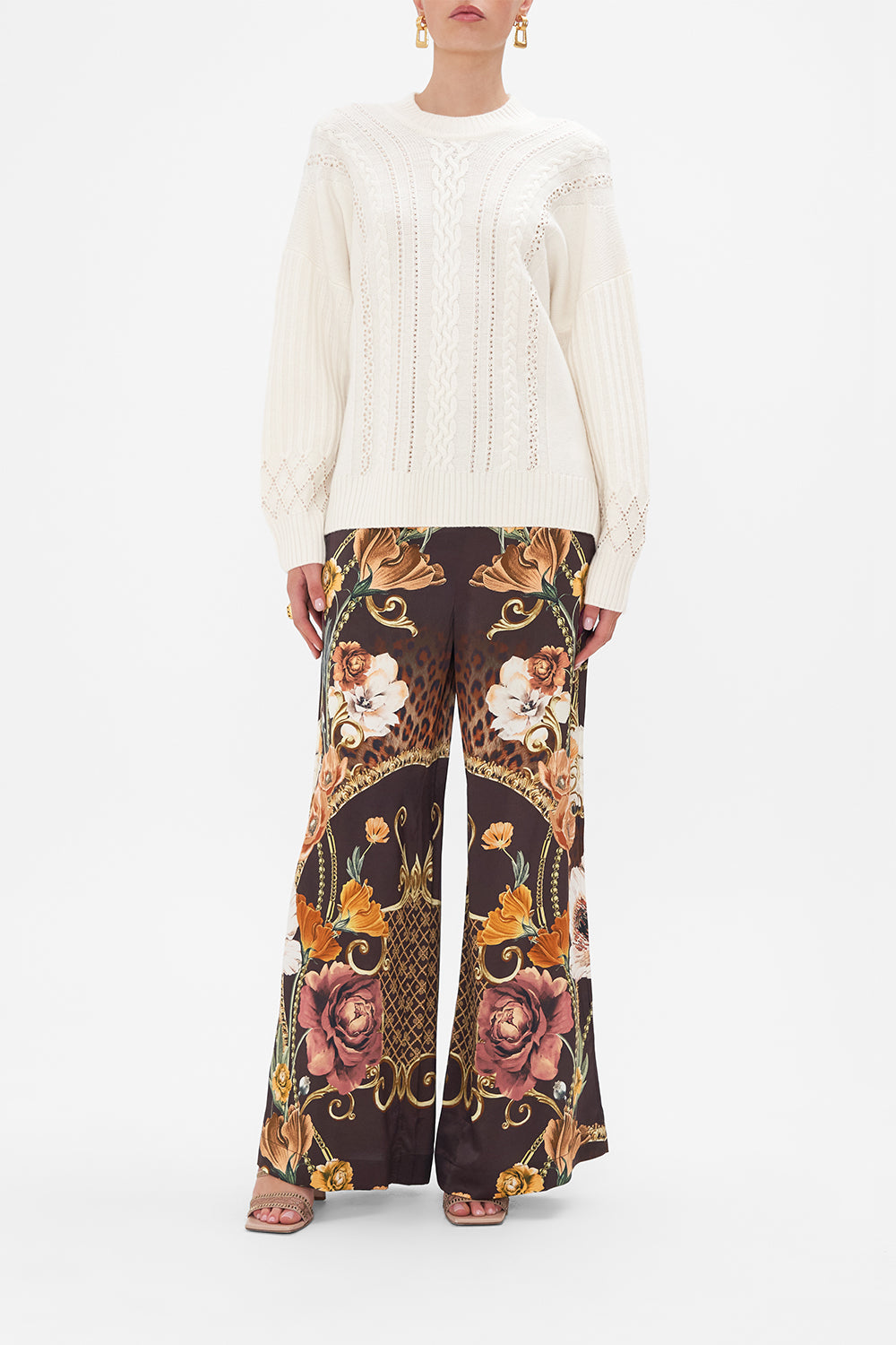 Front view of model wearing CAMILLA cream cable knit jumper in Garden of Good Fortune