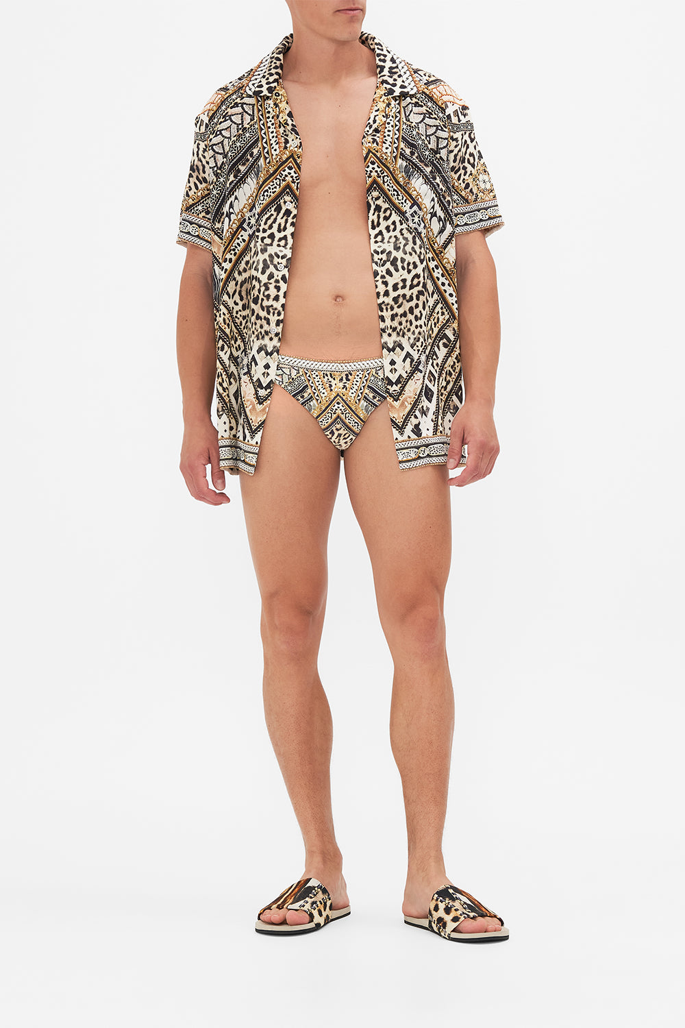 Front view of model wearing Hotel Franks By CAMILLA mens swim breif in Mosiac Muse print