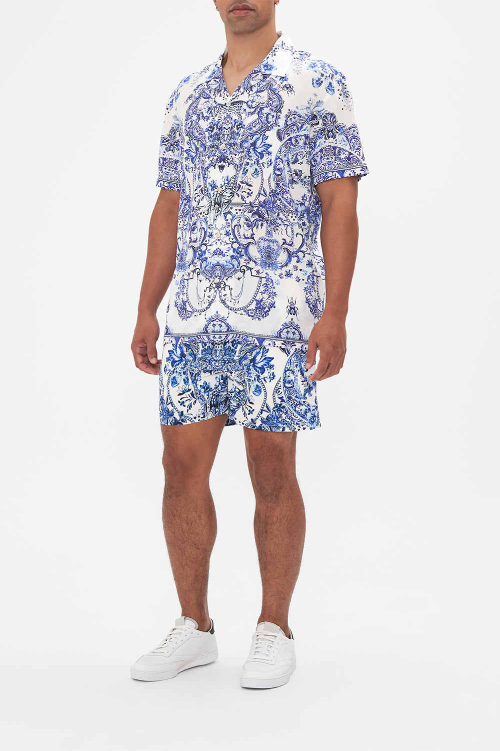 Side view of model wearing Hotel Franks By CAMILLA mens blue and white shirt in Glaze and Graze print