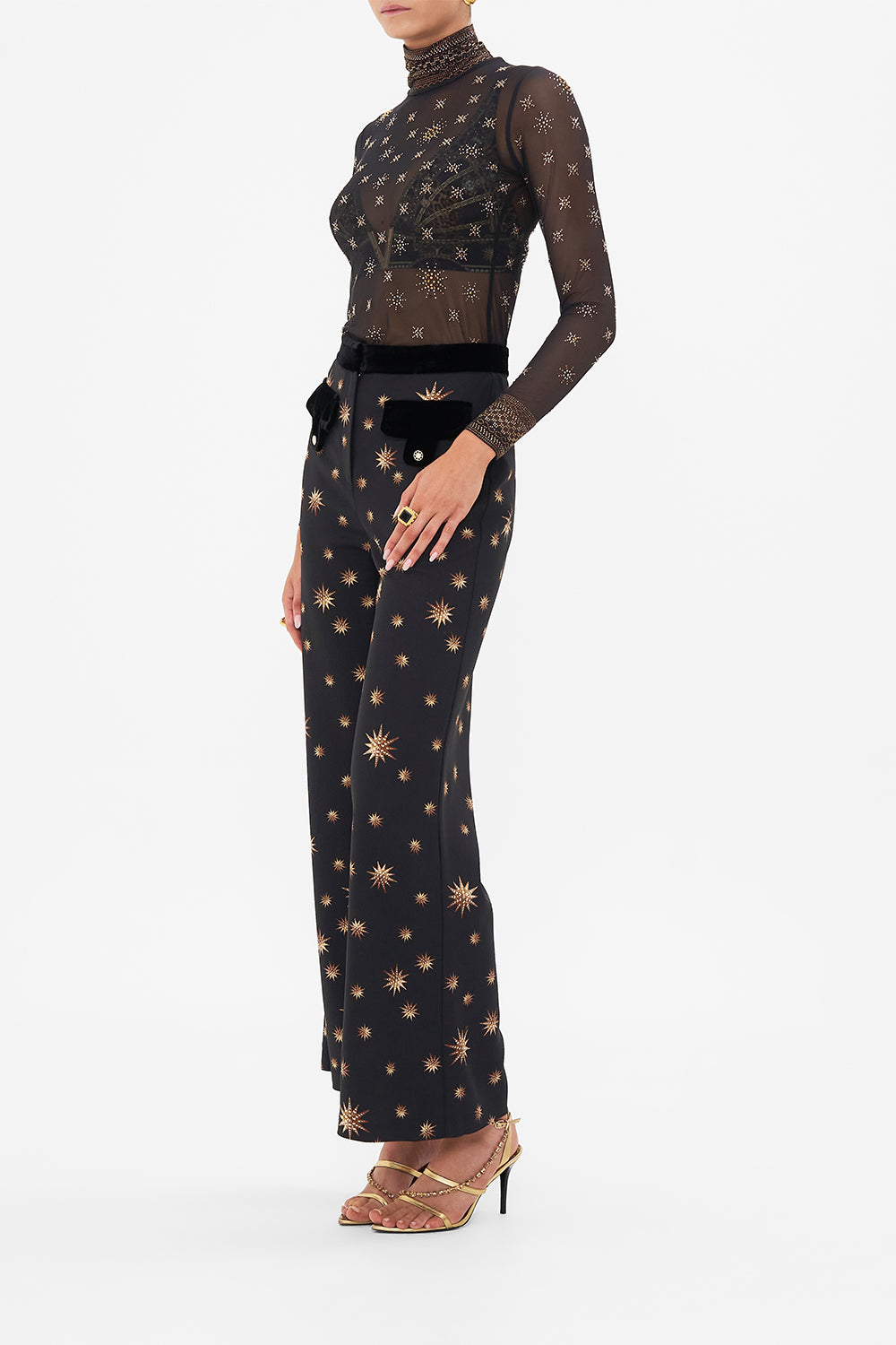 Side view of model wearing CAMILLA mesh turtleneck top in Soul Of A Star Gazer print