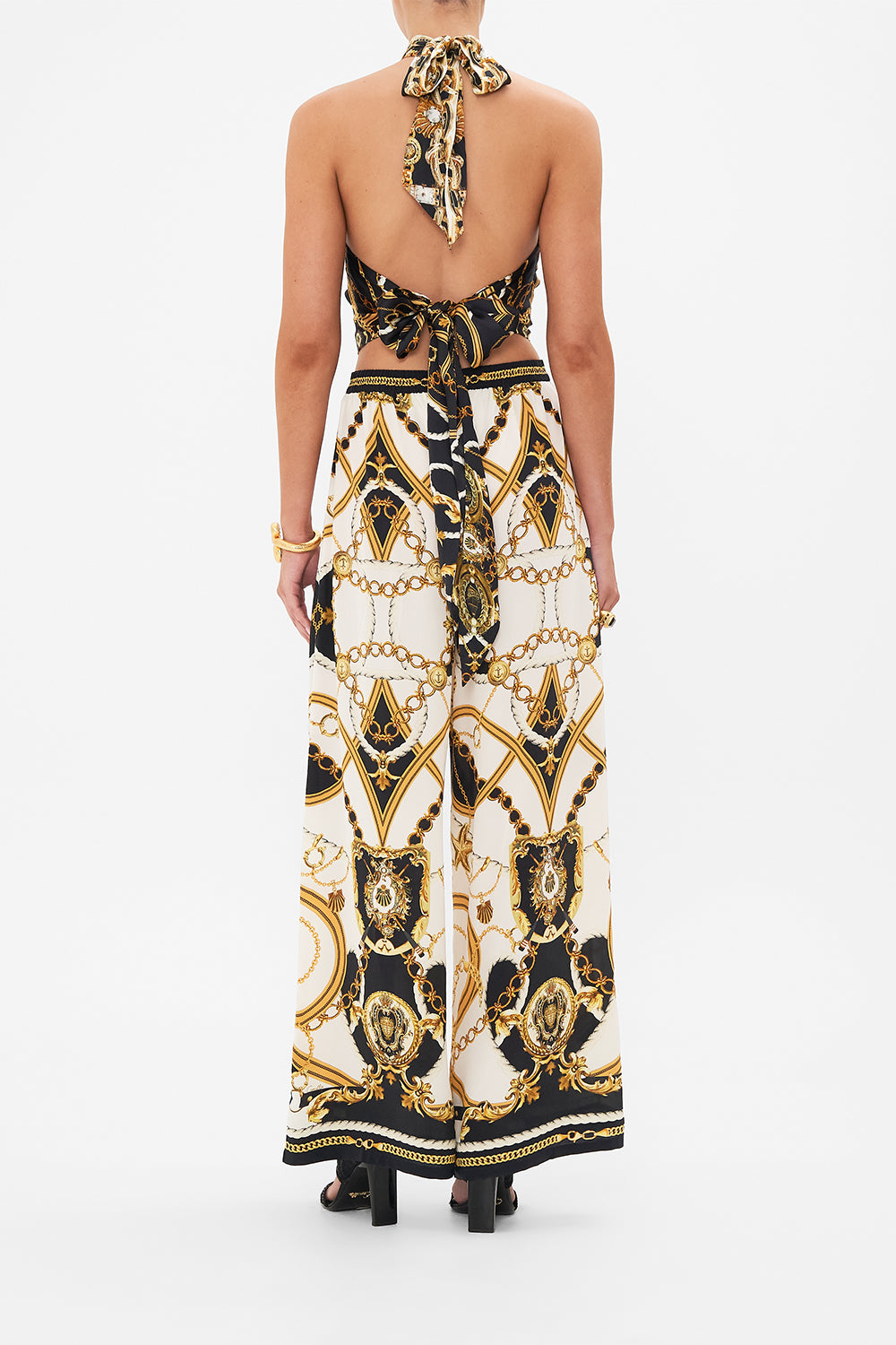 Back view of model wearing CAMILLA silk palazzo pants in Sea Charm print