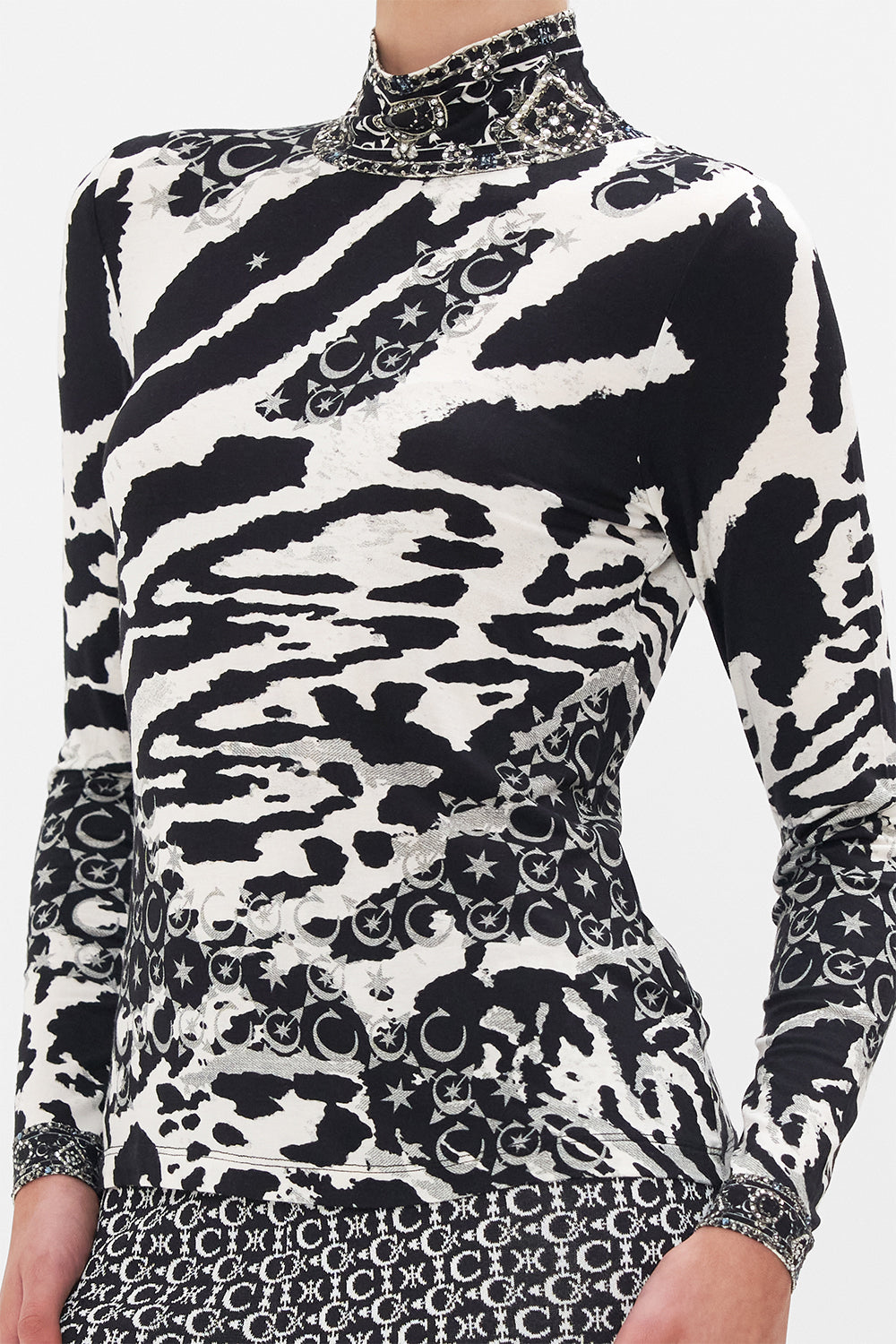 Detail view of model wearing CAMILLA turtleneck top in black and white Feline Fantasy print
