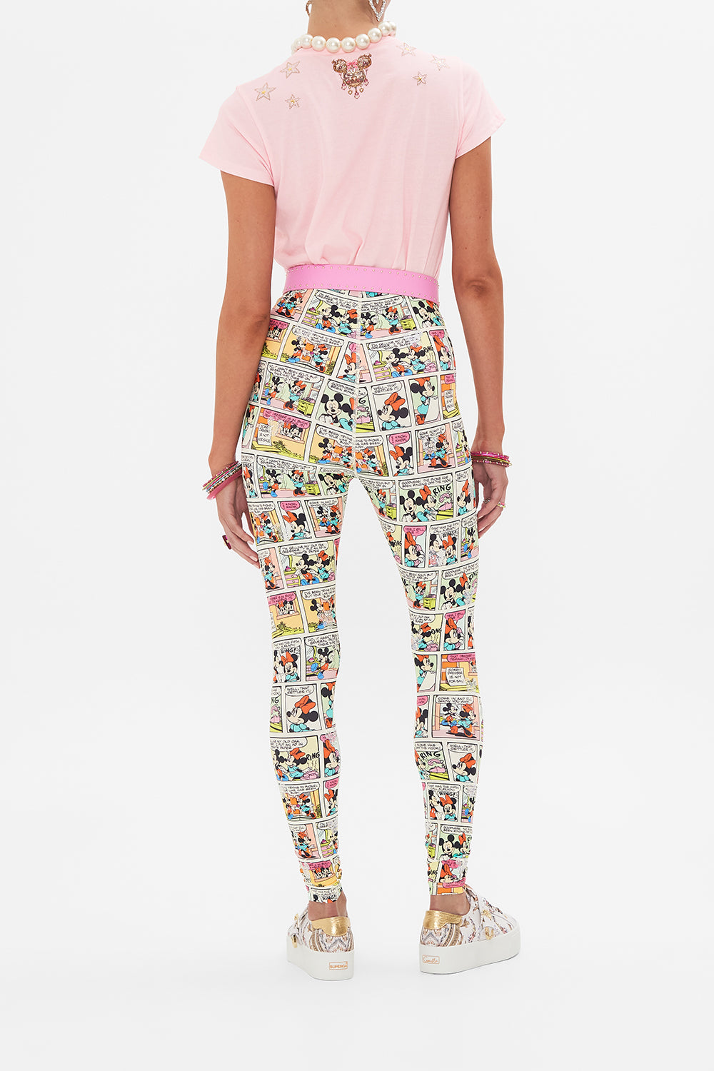 Back view of model wearing CAMILLA x Disney leggings in A Trip Down Comic Strip print