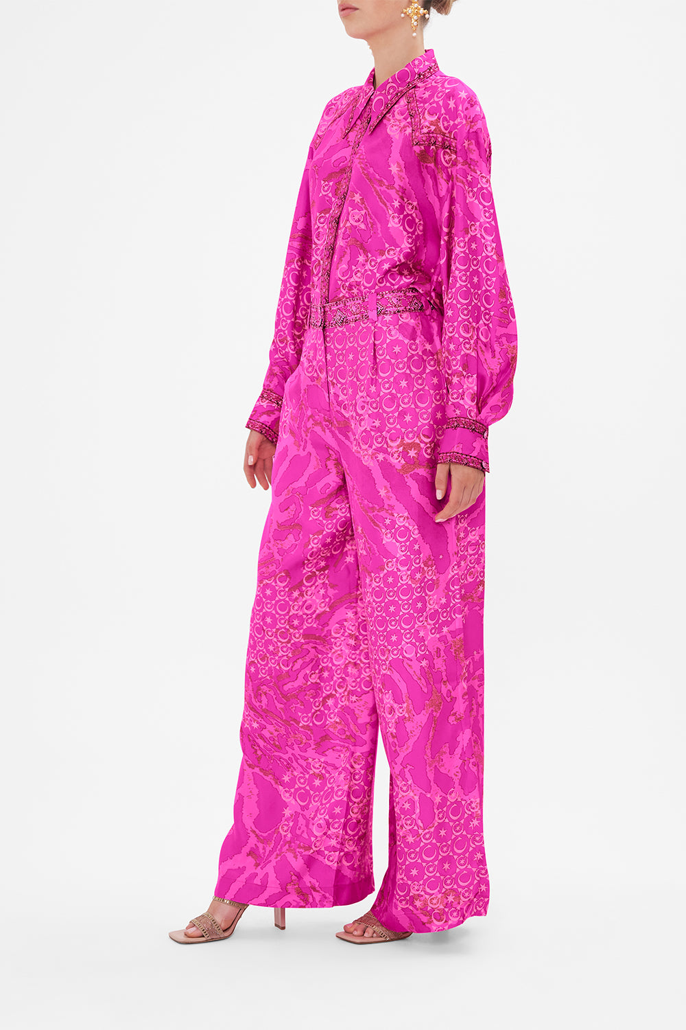 Side view of model wearing CAMILLA silk pants in neon Song Of Sacrifice print