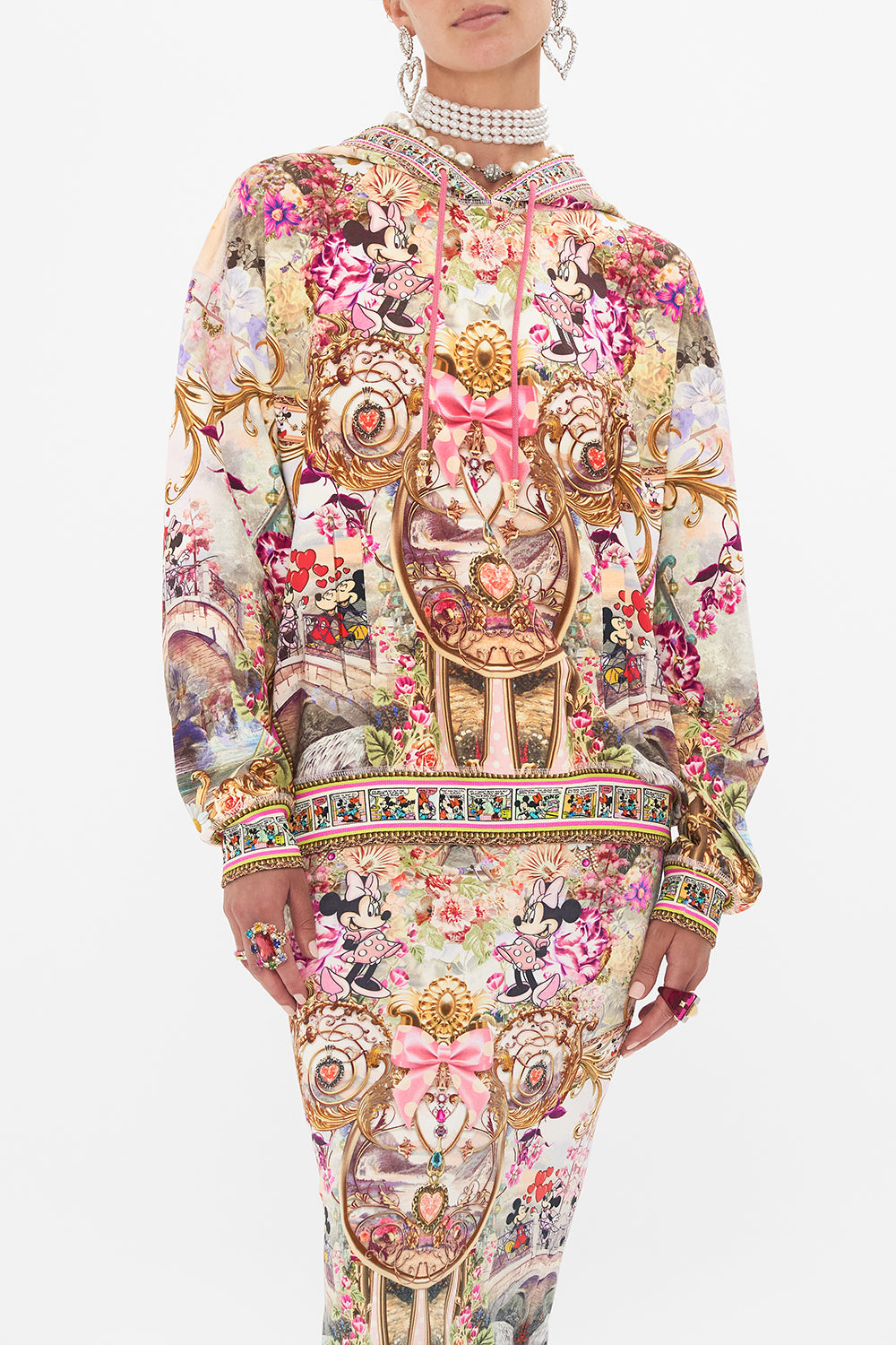 Crop view of model wearing CAMILLA x Disney hoodie in Minnie Mouse Magic print