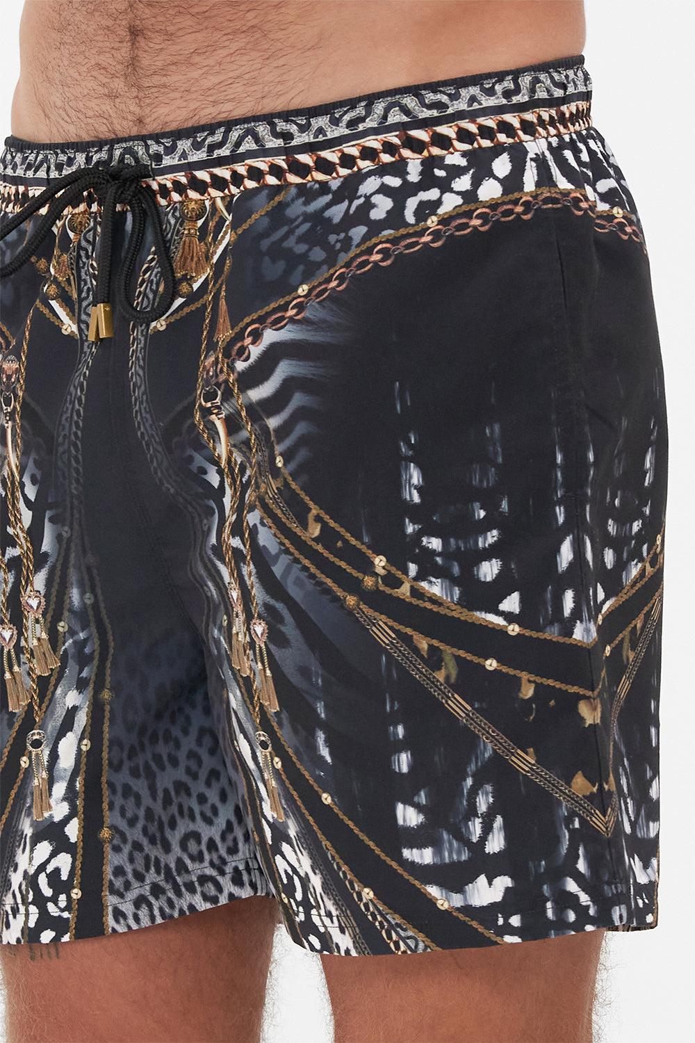 Detail view of model wearing Hotel Franks by CAMILLA mens black boardshorts in Untamed Royalty print
