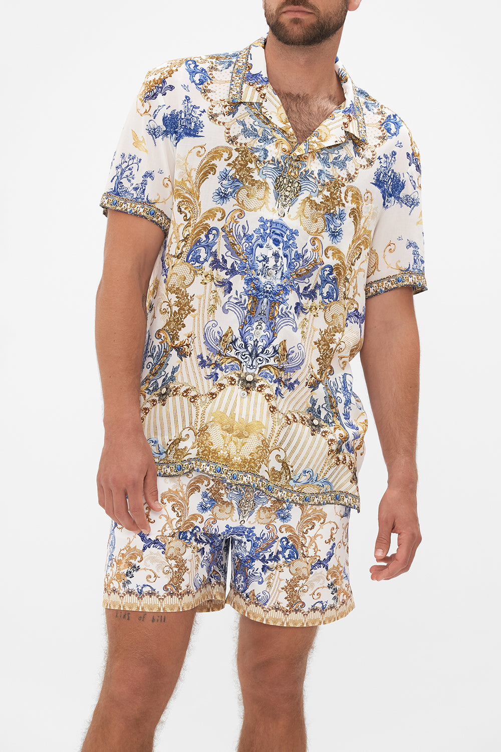 Crop view of model wearing Hotel Franks by CAMILLA mens short sleeve camp collared shirt in white Soul Searching print