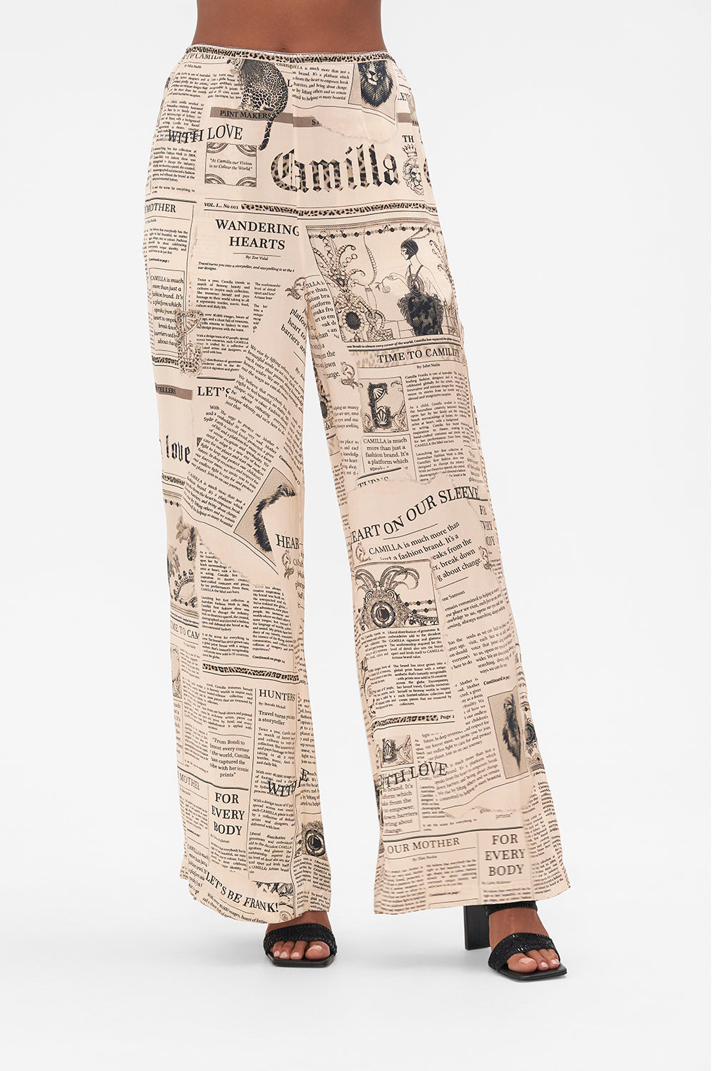 Crop view of model wearing CAMILLA pink silk pants in Fame Fever print