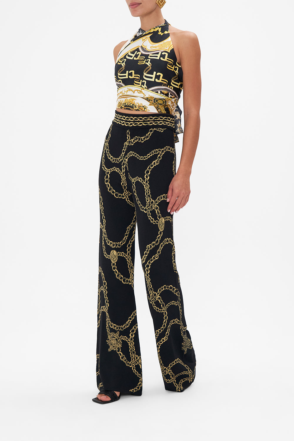 Side view model wearing of CAMILLA flared knit pants in Jealousy And Jewels print