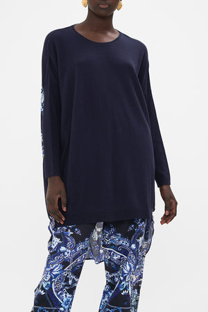 Crop view of model wearing CAMILLA printed jumper in Delft Dynasty print 