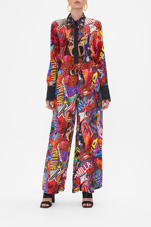Front view of model wearing CAMILLA silk palazzo pants in multicoloured Radical Rebirth print