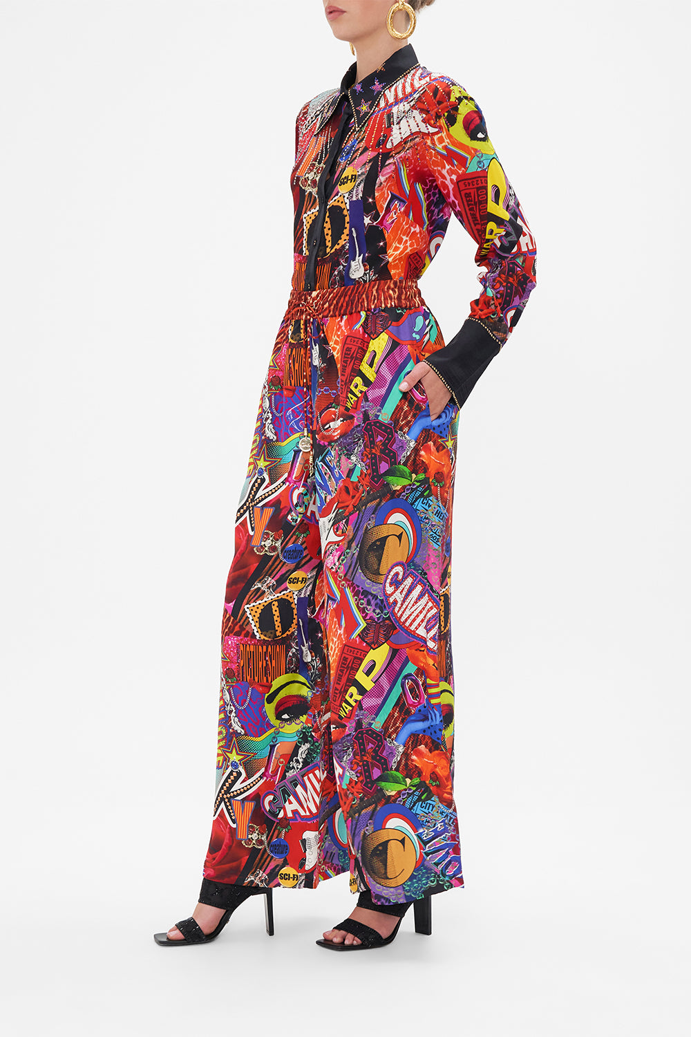 Side view of model wearing CAMILLA silk palazzo pants in multicoloured Radical Rebirth print