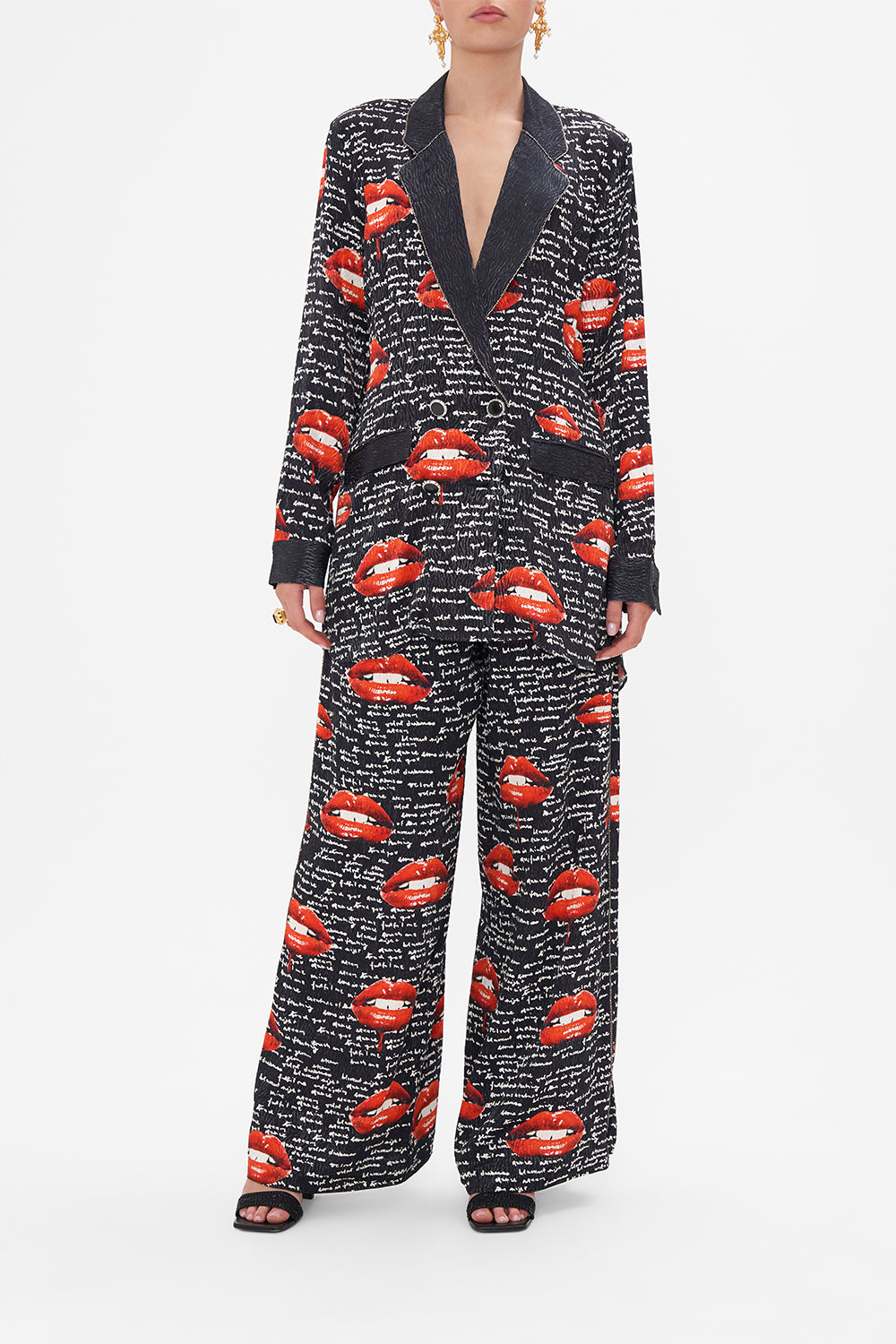 Front view of model wearing CAMILLA black blazer in Chaos Magic print 