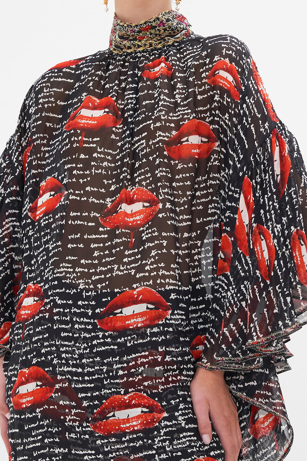 Detail view of model wearing CAMILLA black silk blouse in Chaos Magic print 