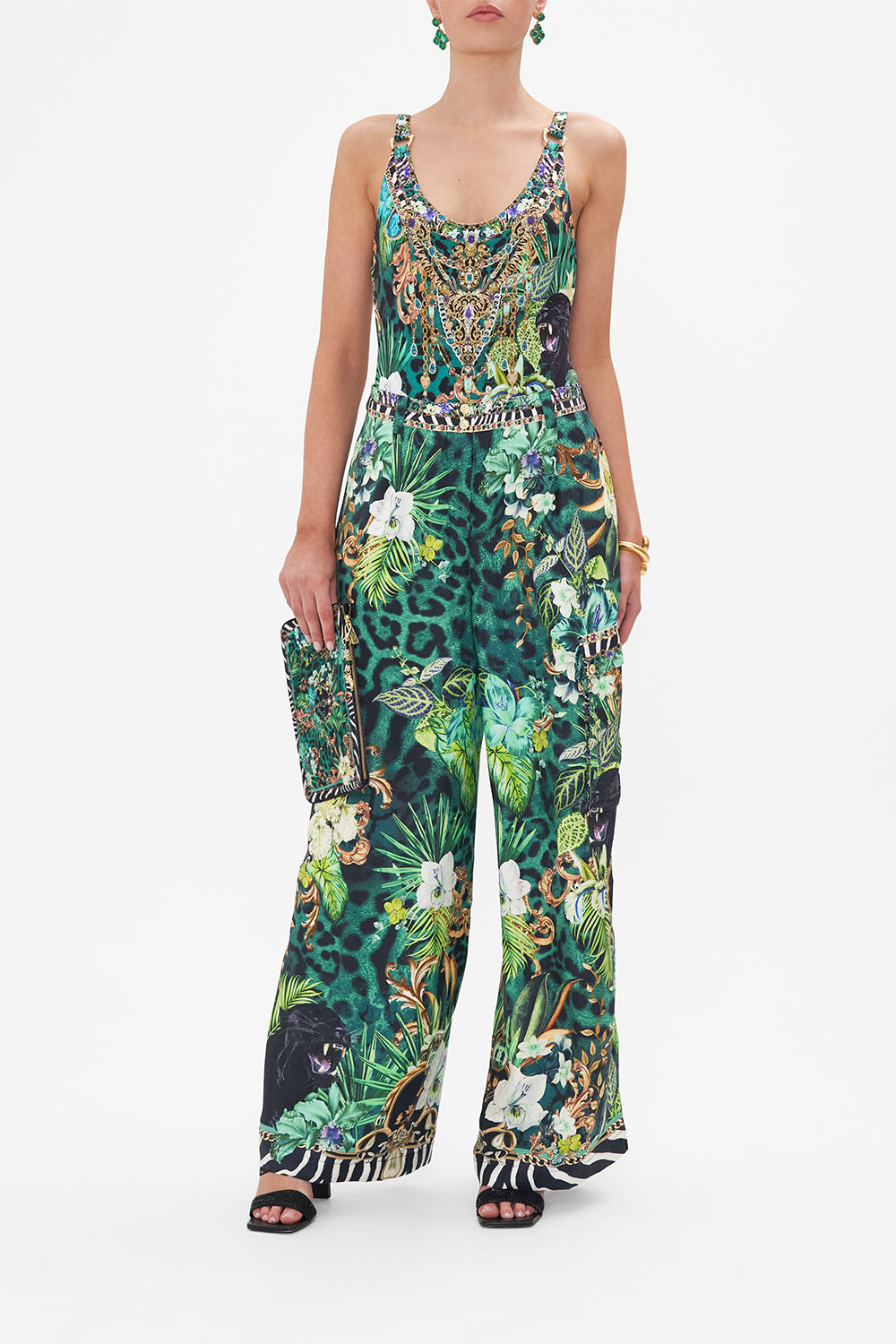 Front view of model wearing CAMILLA green silk cargo pants in Sing My Song print