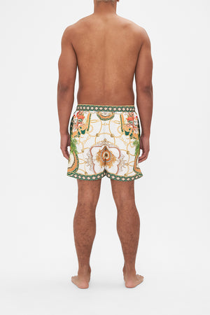 Back view of model wearing Hotel Franks by CAMILLA mens white boardshorts in My Sweet Devotion print