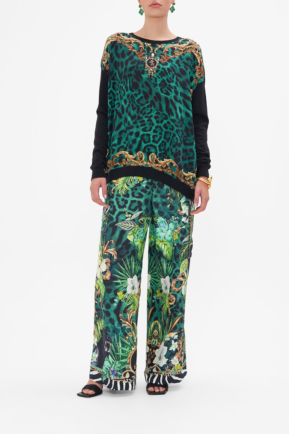 Front view of model wearing CAMILLA green animal print jumper Sing My Song print