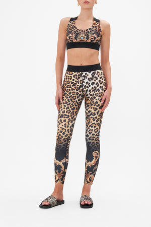 Front view of model wearing CAMILLA leopard print sports bra in Running In The Wild print