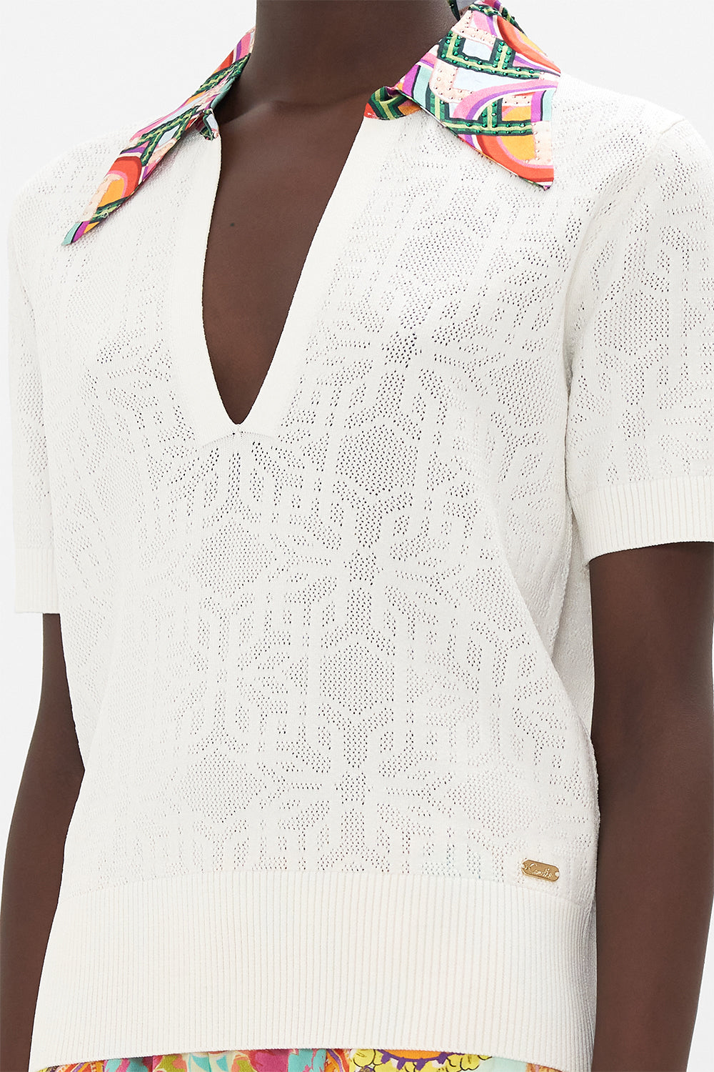 Detail view of model wearing CAMILLA white knit polo  top in An Italian Welcome print