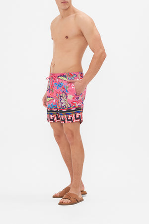 Side view of model wering HOTEL FRANKS BY CAMILLA mens boardshort in Rome Retro print