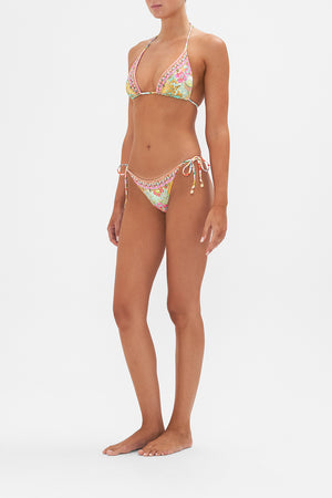 Side view of model wearing of CAMILLA swimwear reversible bikini bottom in An Italian Welcome print