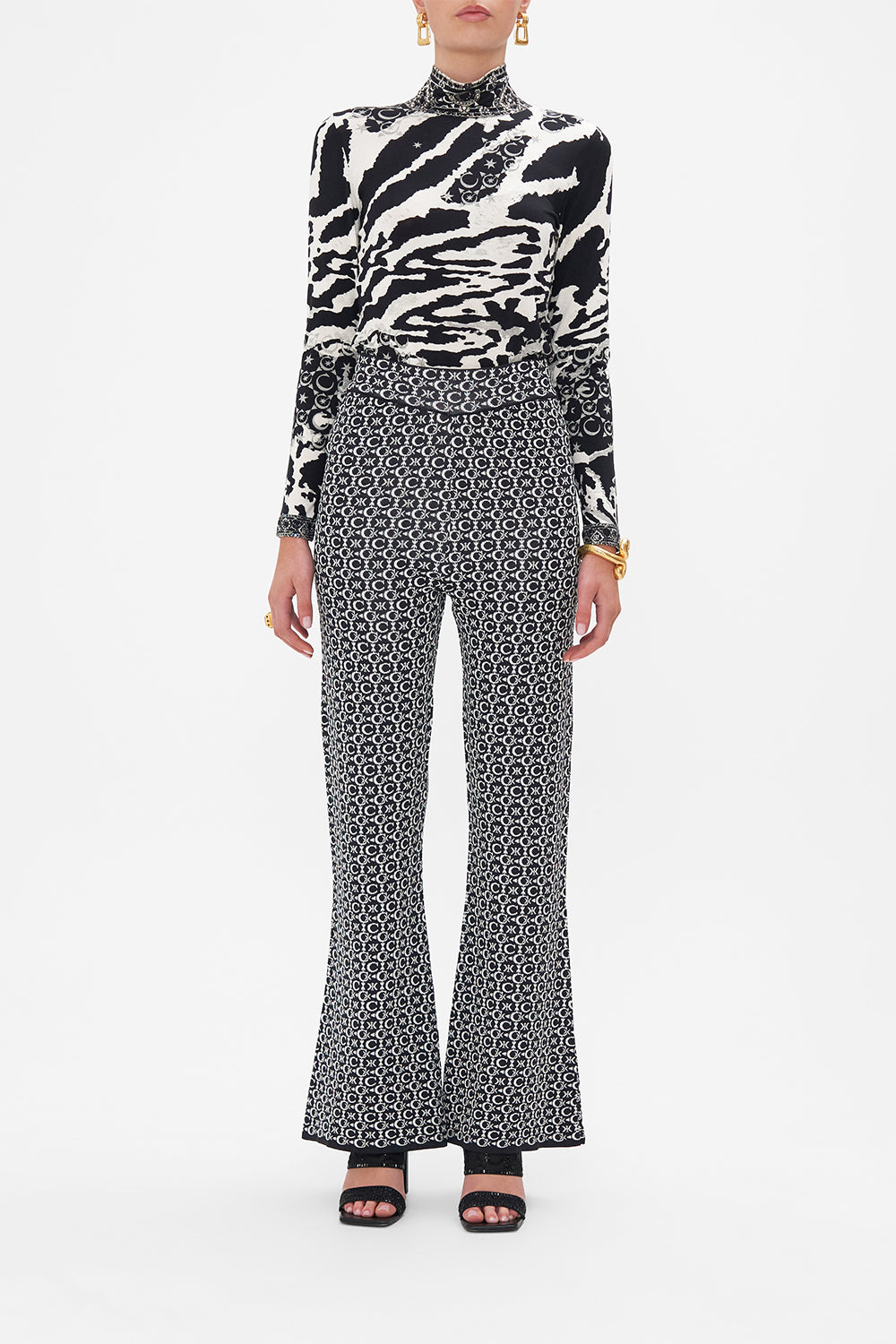Front view of model wearing CAMILLA flared knit pants in Feline Fantasy print