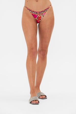 Crop view of model waering CAMILLA resortwear bikini bottom in Heart Like A Wildflower print