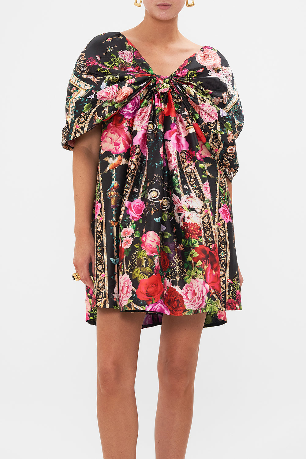 Crop view of model wearing CAMILLLA taffeta mini dress in Reservation For Love print