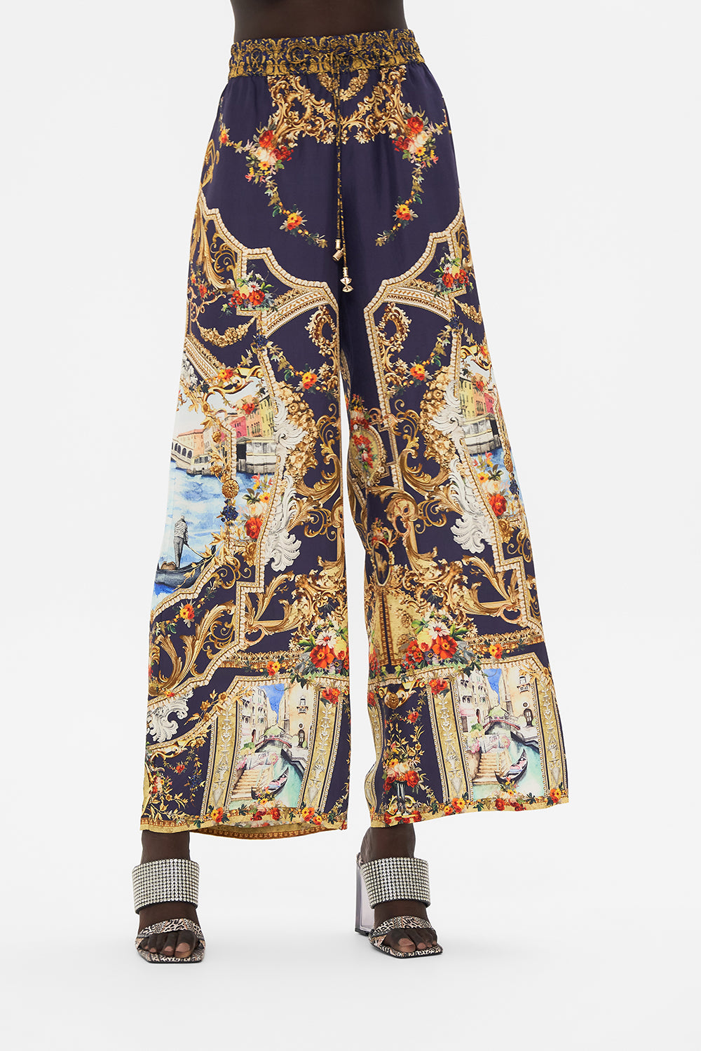Crop view of model wearing CAMILLA silk pants in Venice Vignette print
