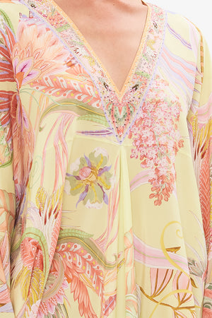 Detail view of model wearing CAMILLA designer silk floral kaftan in Cosmic Tuscan print