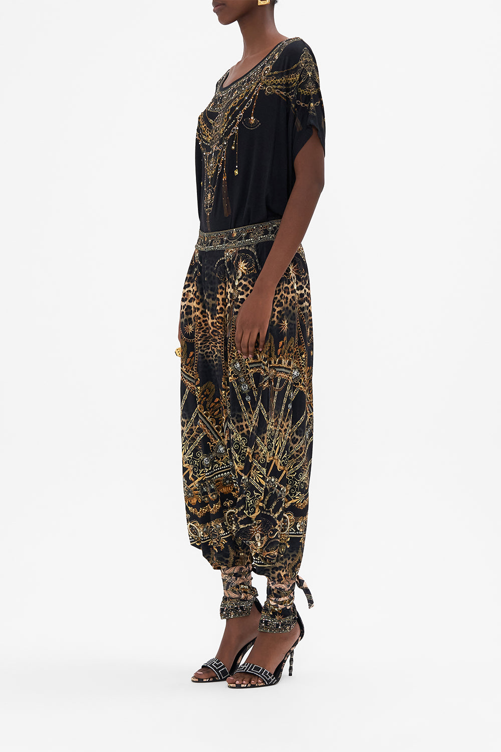 Side view of model wearing CAMILLA luxury graphic tee in Masked At Moonlight print