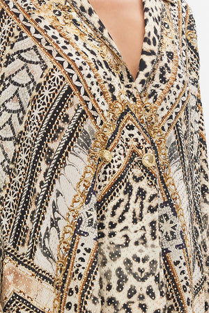 Detail view of model wearing CAMILLA silk coat in Mosaic Muse print