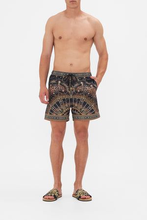 Front view of model wearing hotel franks By CAMILLA mens boardshort in Masked At Moonlight print