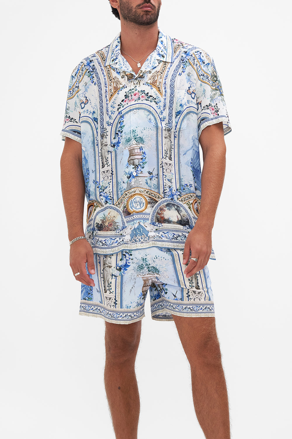 Crop view of model wearing HOTEL FRANKS BY CAMILLA collared shirt in Season of the Siren print