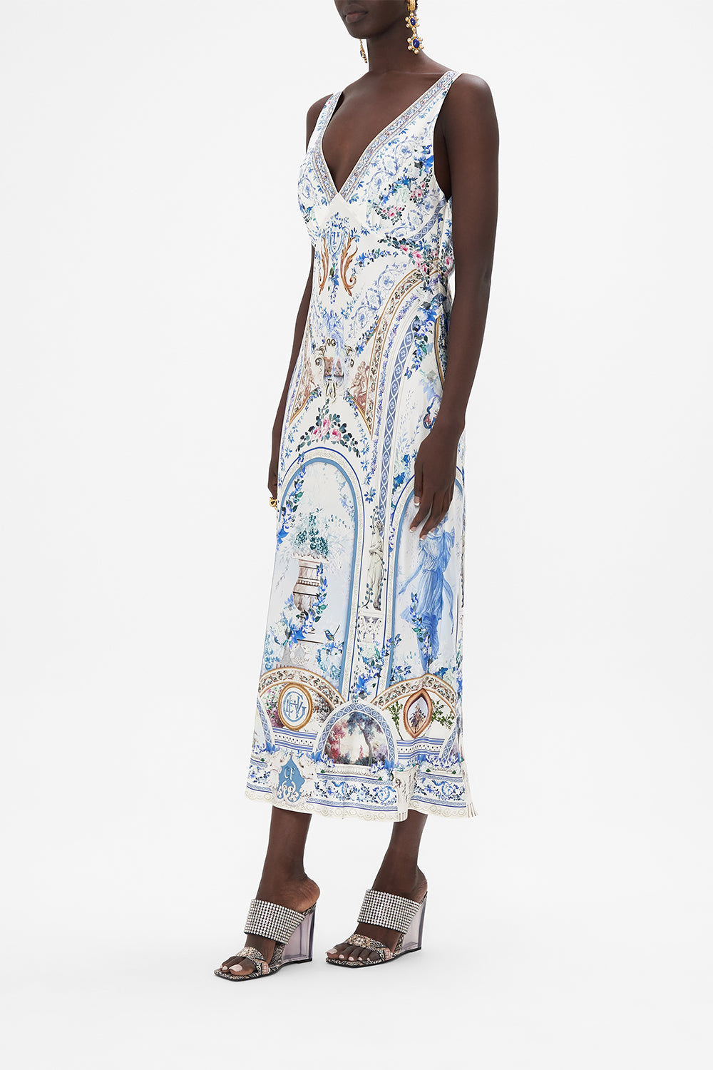 Side view of model wearing CAMILLA silk slip dress in Season of The Siren print 