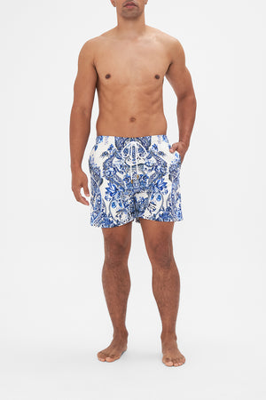 Front view of model wearing Hotel Franks By CAMILLA blue and white mens boardshorts in Glaze and Graze print