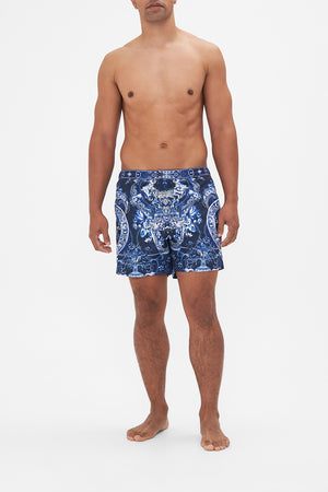 Front view of model wearing Hotel Franks By CAMILLA mens blue swim shorts in Delft Dynasty print