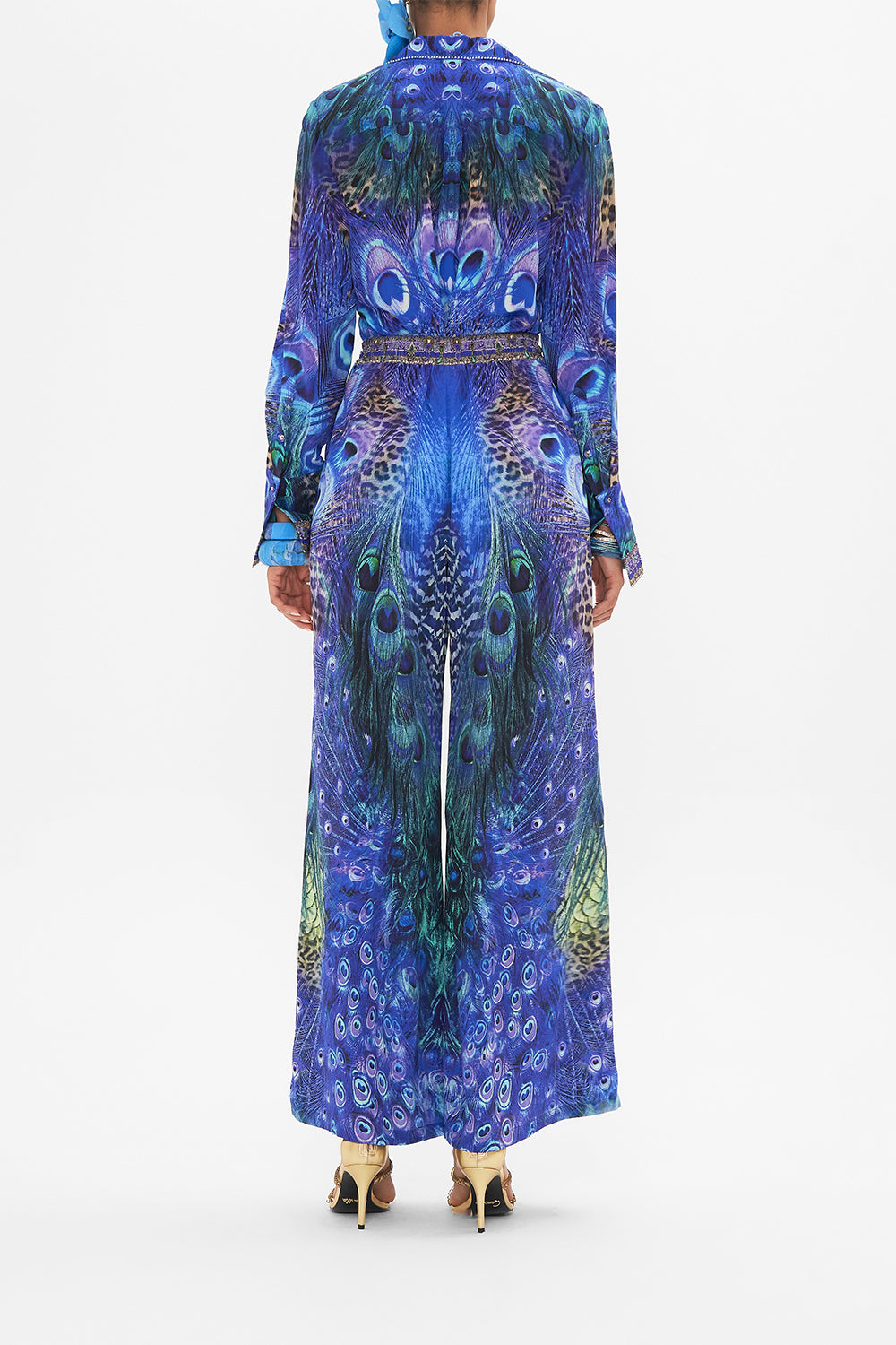 Back view of model wearing CAMILLA silk pants in Peacock Rock print