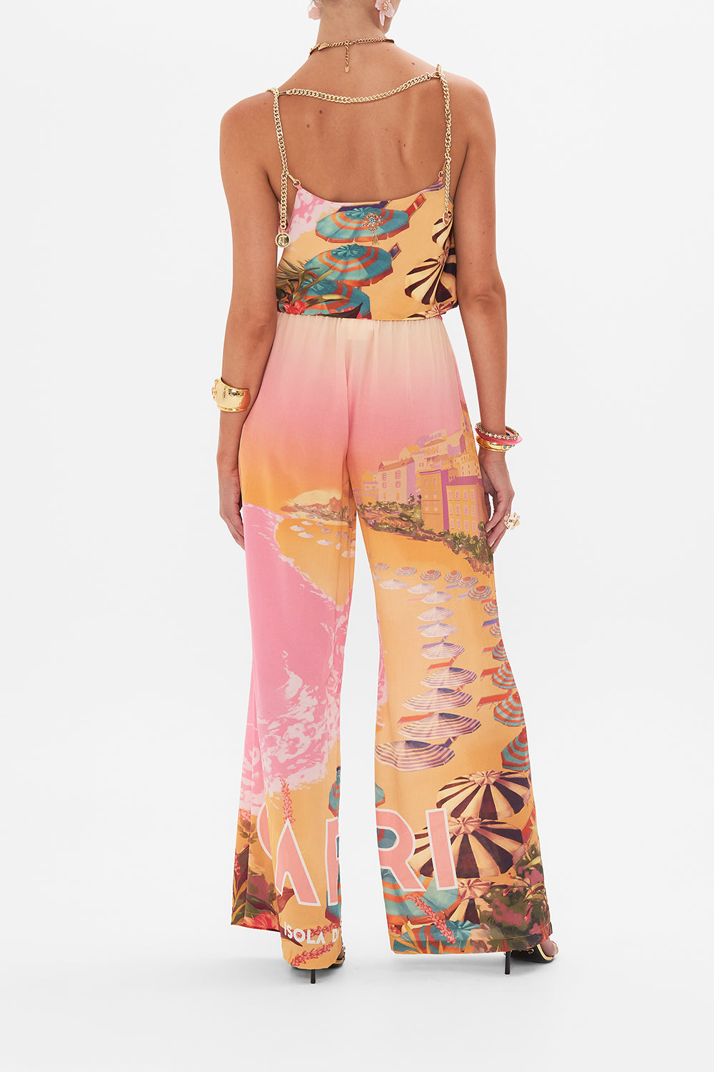 Back view of model wearing CAMILLA silk lounge pant in Capri Me print