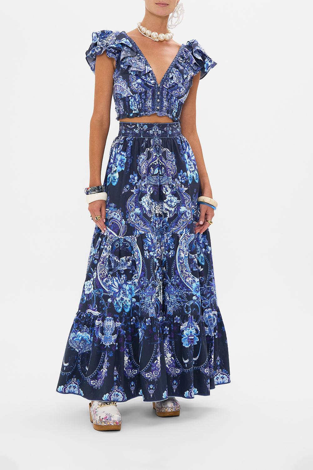 Front view of model wearing CAMILLA ruffle top in Delft Dynasty print 