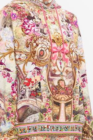 Detail view of model wearing CAMILLA x Disney hoodie in Minnie Mouse Magic print