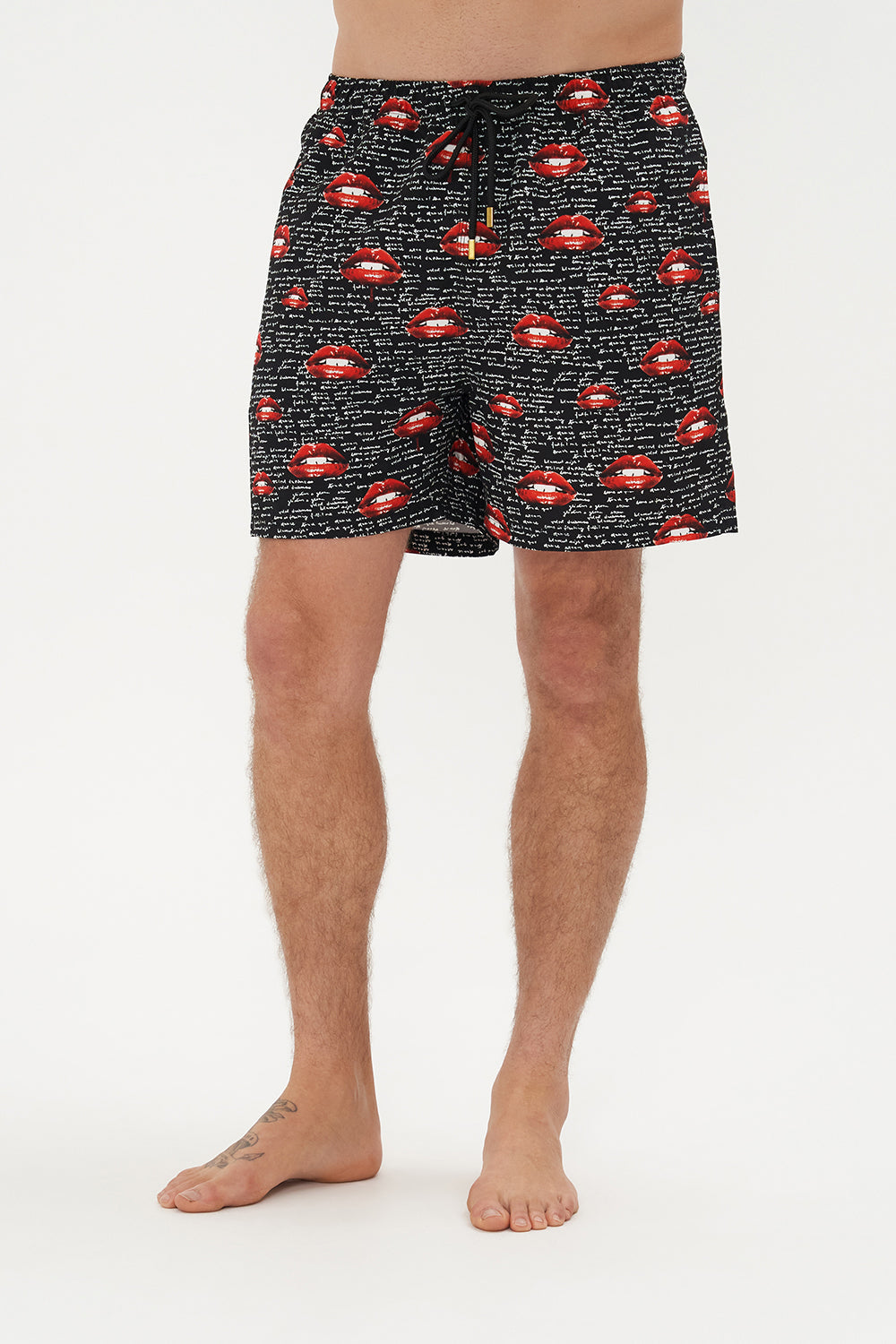 Crop view of model wearing Hotel Franks by CAMILLA mens elastic waist boardshorts in black Chaos Magic Print 