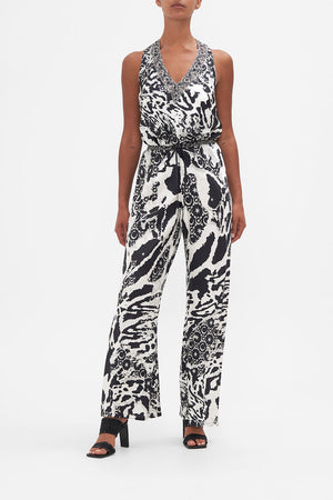 Front view of model wearing CAMILLA black and white silk pants in Feline Fantasy print