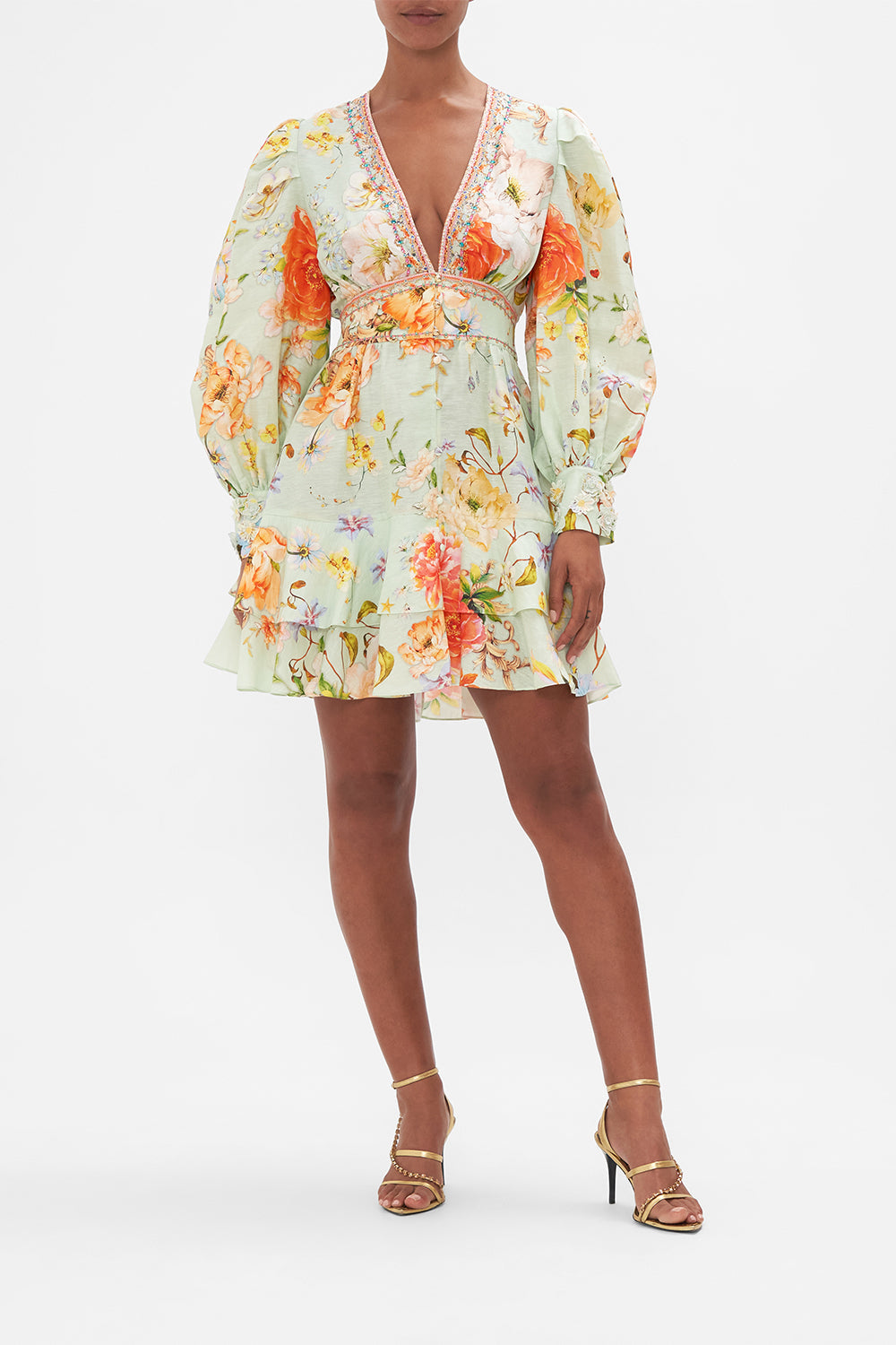 Front view of model wearing CAMILLA green floral mini dress in Talk The Walk print