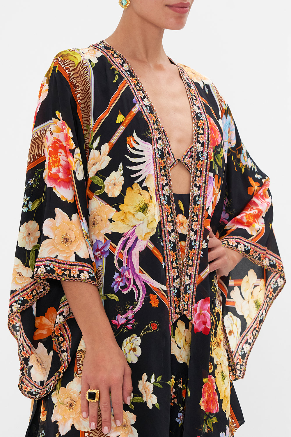 Detail view model wearing of CAMILLA floral silk kimono layer in Secret History print