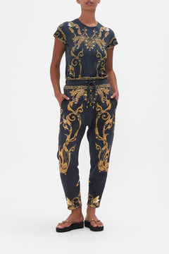 Front view of model wearing CAMILLA trackpants in Moonlight Melodies print